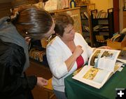 Reviewing Book. Photo by Pam McCulloch, Pinedale Online.