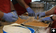 Breading the catfish. Photo by Dawn Ballou, Pinedale Online.