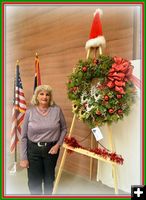 Julie Early and her wreath. Photo by Terry Allen.