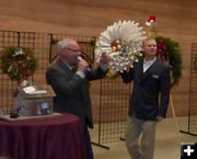 Auctioning Sublette BOCES wreath. Photo by Dawn Ballou, Pinedale Online.