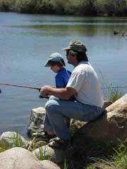 Dad and son fishing together. Photo by Pinedale Online.