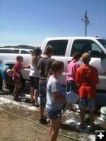 Cleaning the trucks. Photo by Ranae Pape, Sublette County Extension Office.