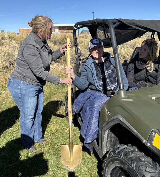 Rusty holds golden shovel. Photo by Dawn Ballou, Pinedale Online.